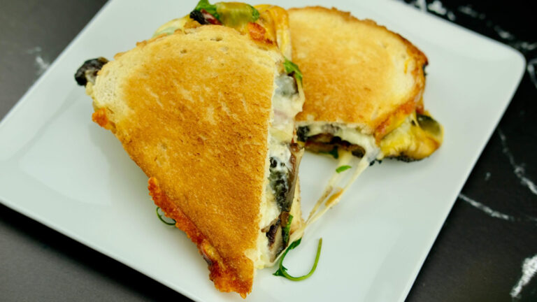 Smoky Portobello Grilled Cheese Sandwich plated on a white square dish