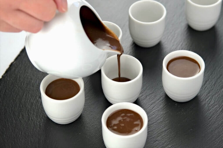 spiced chocolate budino being poured in serving cups for chilling