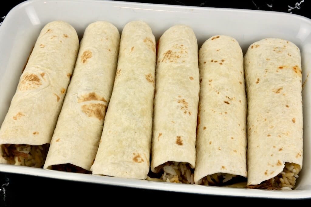 rolled birria enchiladas ready for baking