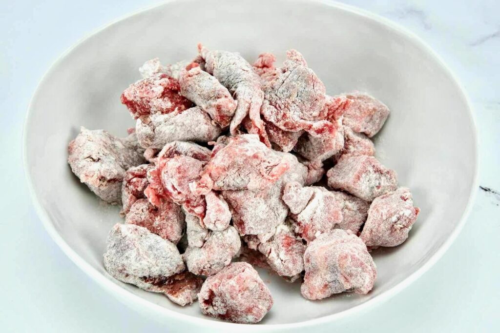 beef cuts tossed in flour for the Beef and Red Wine Slow Cooker Stew recipe