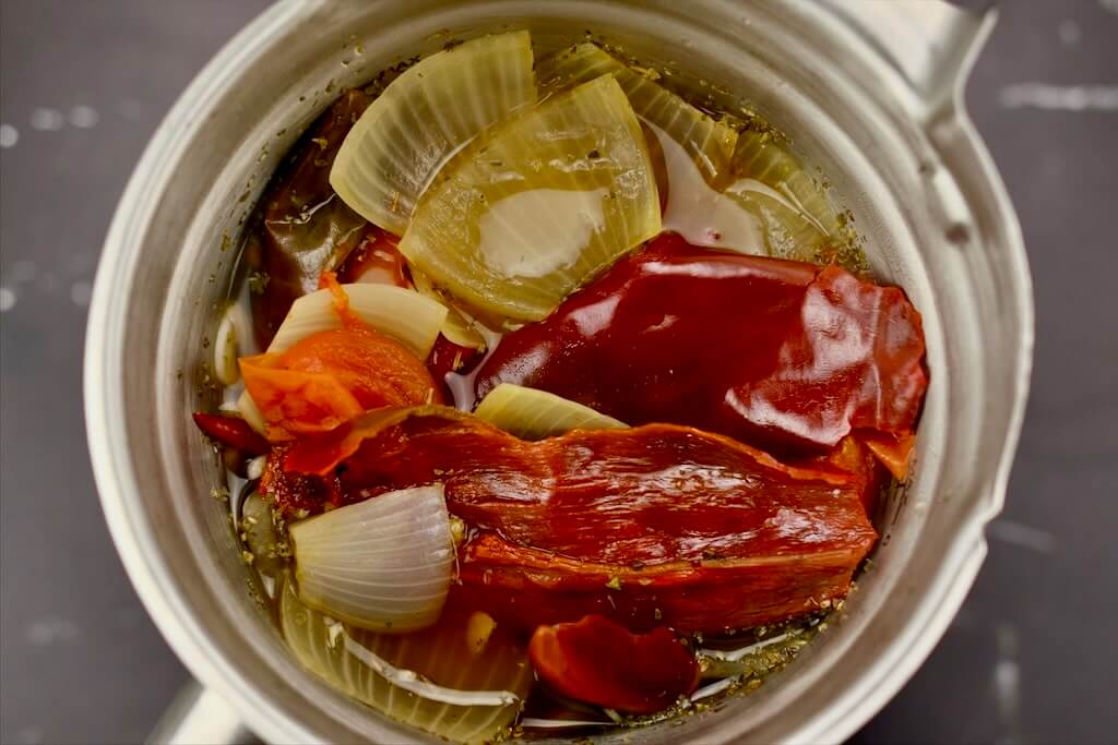 sauteed ingredients in the blender for birria enchiladas recipe