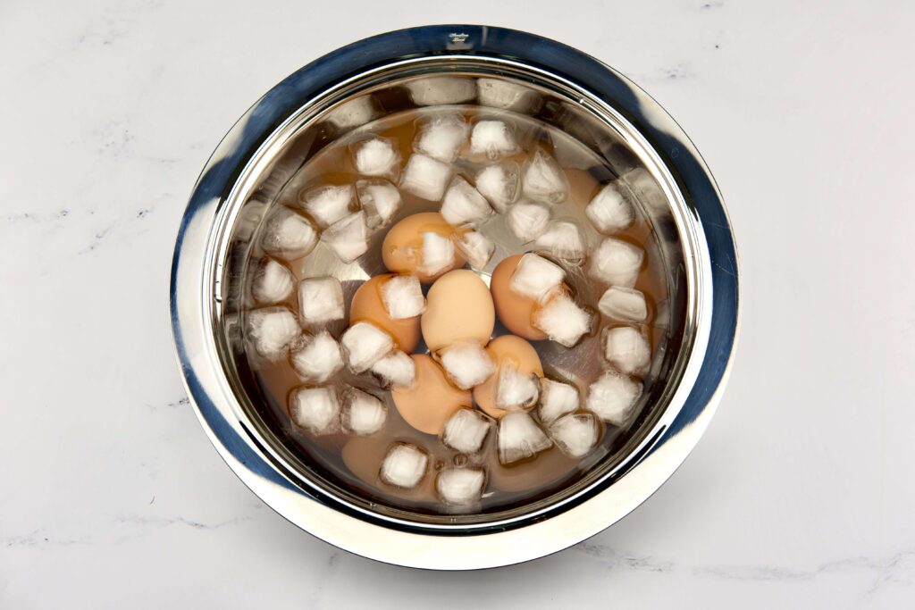 boiled brown egggs in ice bath