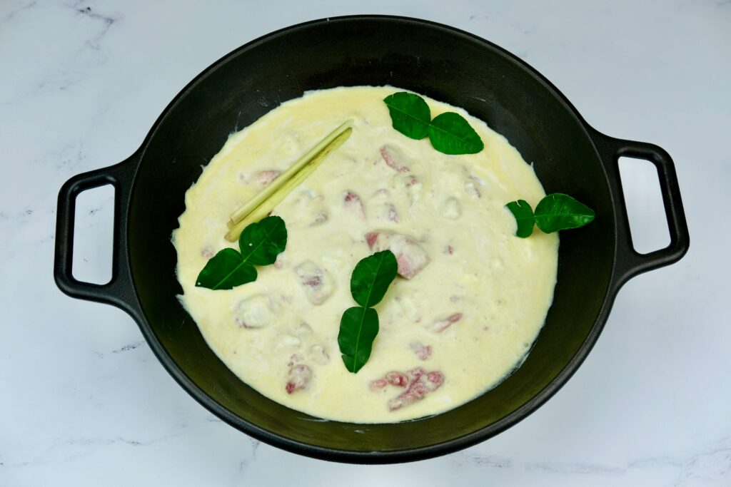beef simmering in the sauce made from coconut milk and aromatics