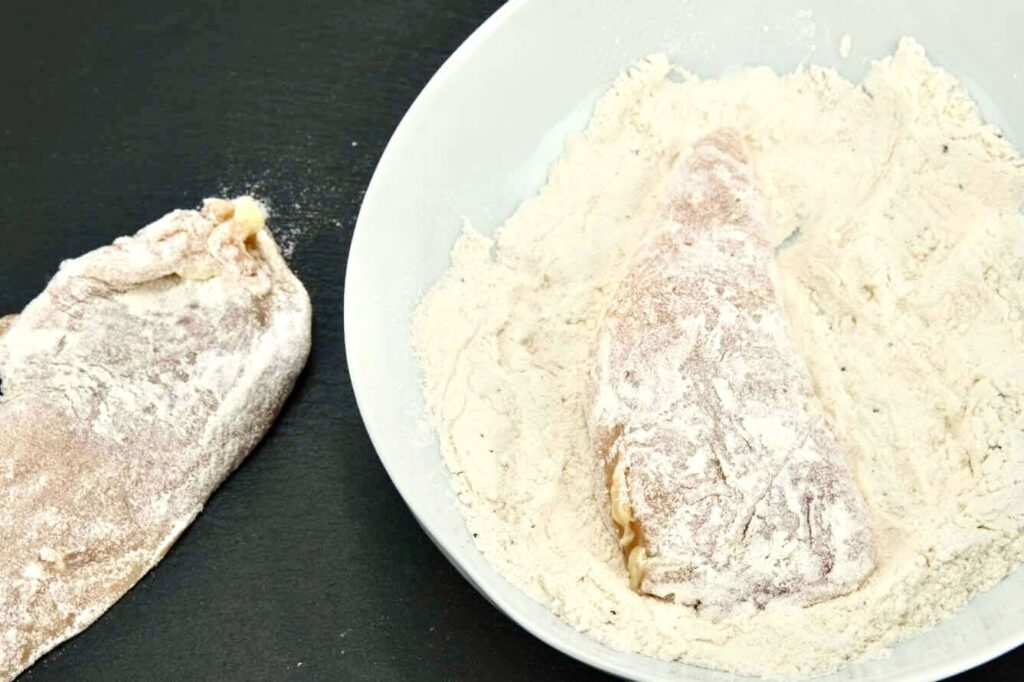 raw chicken coated in flour with spices for chicken marsala recipe
