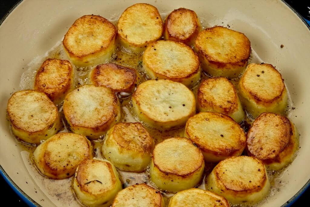 cooking the potatoes undisturbed until a deep, brown crust has formed