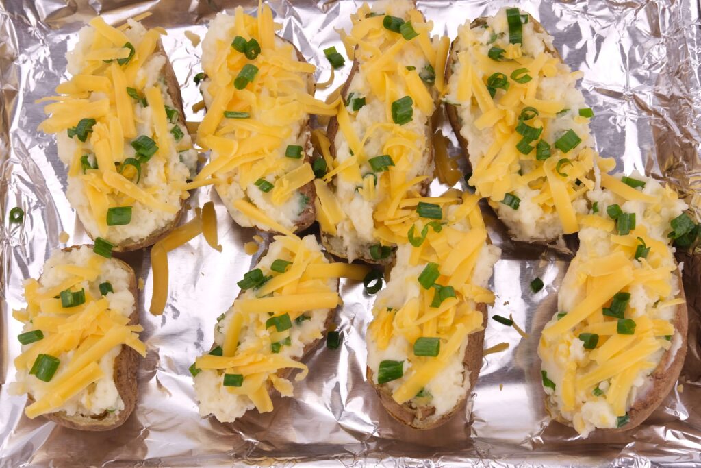 mashed potatoes with duck fat, butter, cheddar cheese and green onions ready for baking