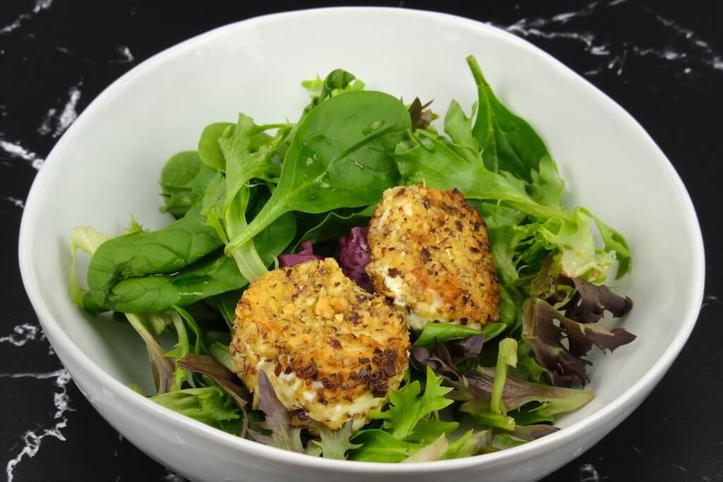 a bowl of warm chevre salad