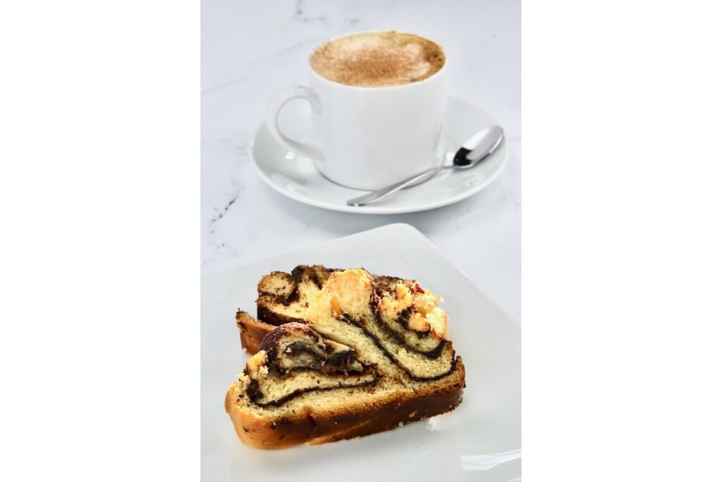 freshly made chocolate babka bread with a cup of coffee