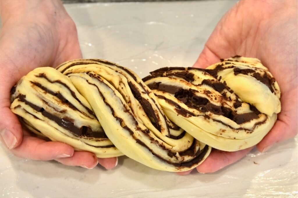 twisted babka dough filled with chocolate filling with cinnamon and espresso powder