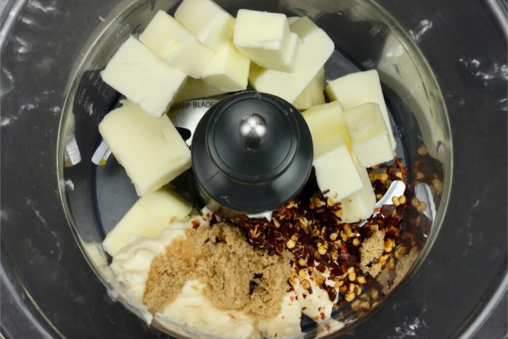 roasted shallot and garlic with softened butter, mayonnaise, crushed red pepper and brown sugar in a blender