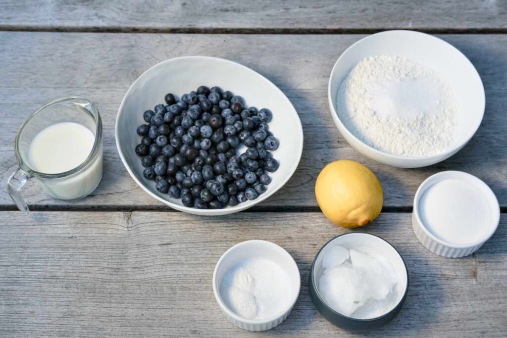 ingredients for vegan sweet biscuits with blueberries and whipped cream