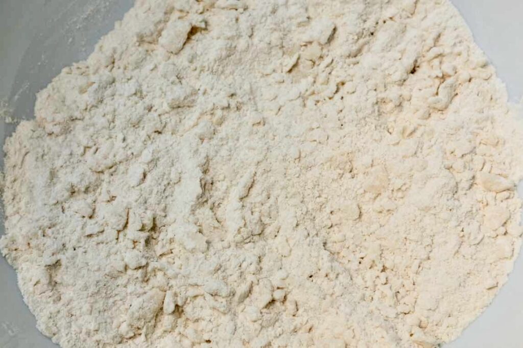 A mixture of flour, baking powder, sugar, and salt with coconut oit for vegan sweet biscuits