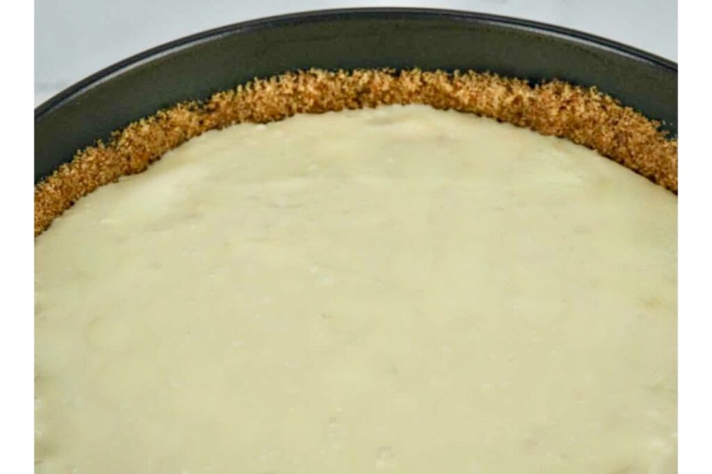 graham crust with batter ready for baking