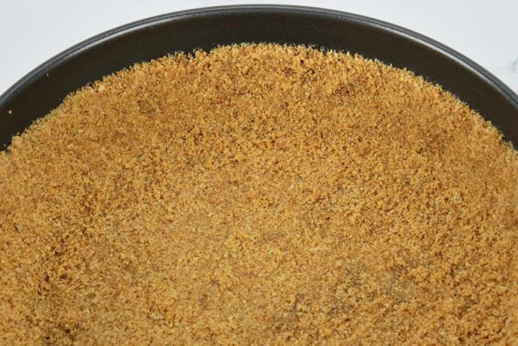pressed graham cracker crumbs and sugar with butter for the creamy cheesecake crust