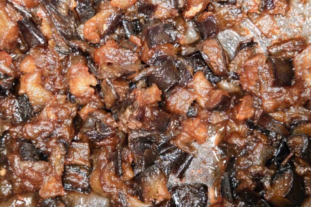 cooked diced eggplant seasoned with sugar, salt, orange zest, and spices