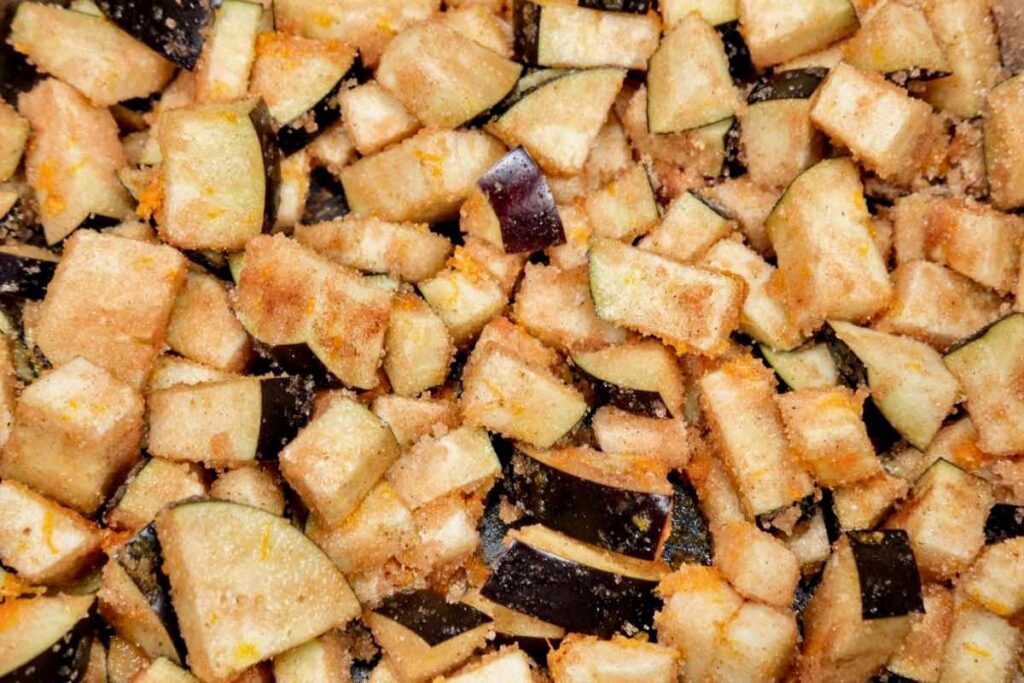 diced eggplant sprinkled with sugar, salt, orange zest, and spices - for eggplant jam recipe