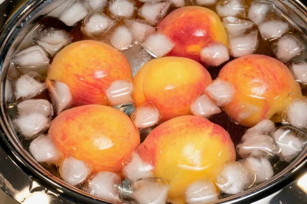 boiled peaches in ice bath