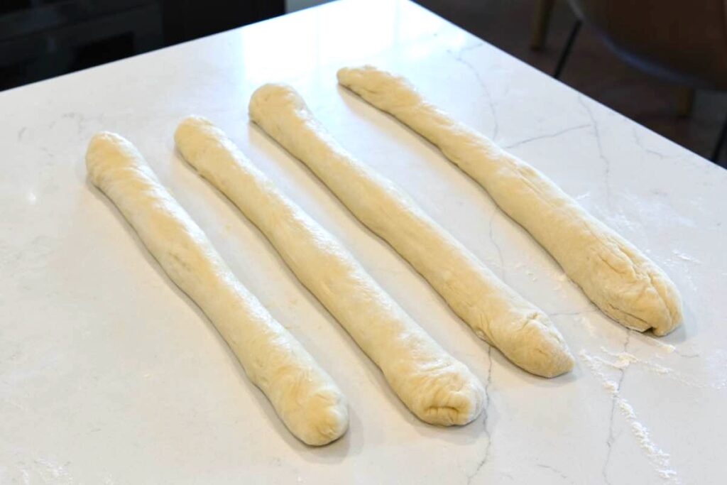 long ropes of challah dough ready for braiding