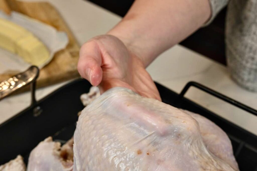 carefully separate the skin from the meat to insert the butter