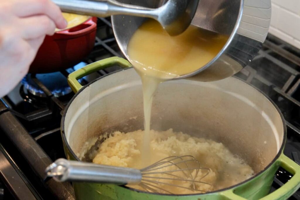 stock being added to a roux to make the Thanksgiving gravy